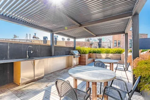 a view of a patio with a table and chairs under an umbrella