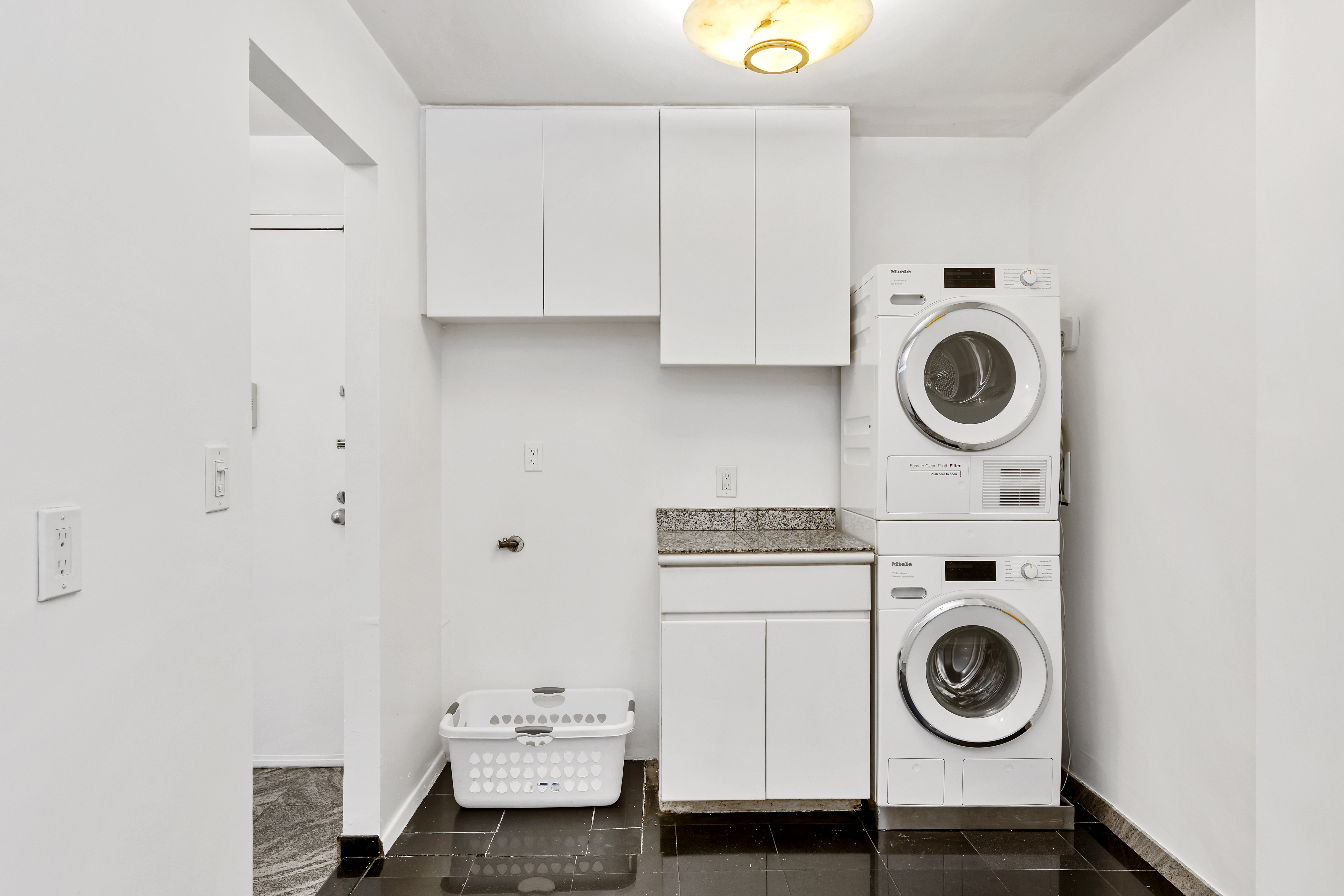 1 Irving Place, Unit U7BC Manhattan, NY 10003 - Photo 4 of 20 a utility room with sink dryer and washer
