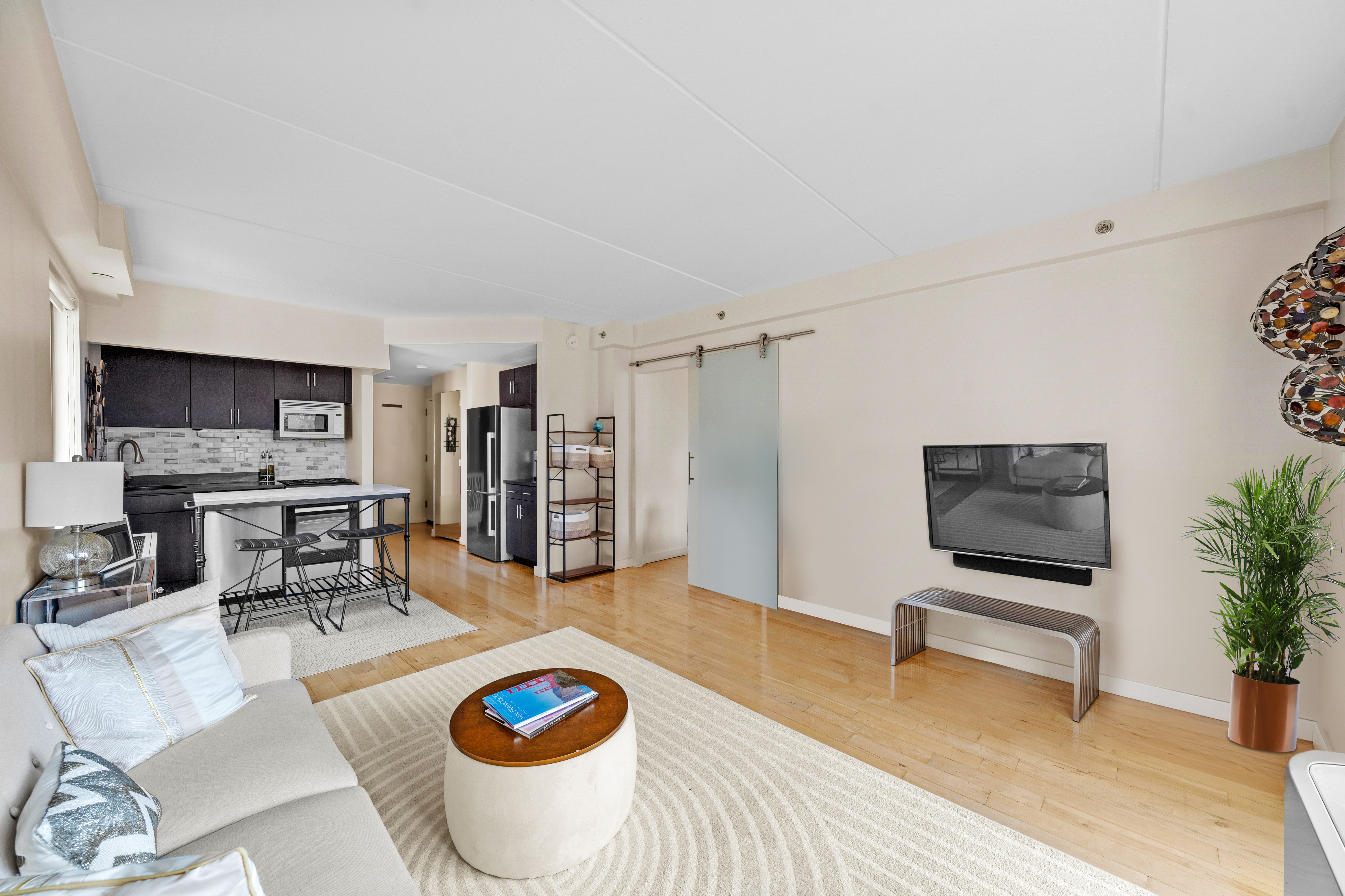 1810 3rd Avenue, Unit A9B Manhattan, NY 10029 - Photo 3 of 16 a living room with furniture and wooden floor