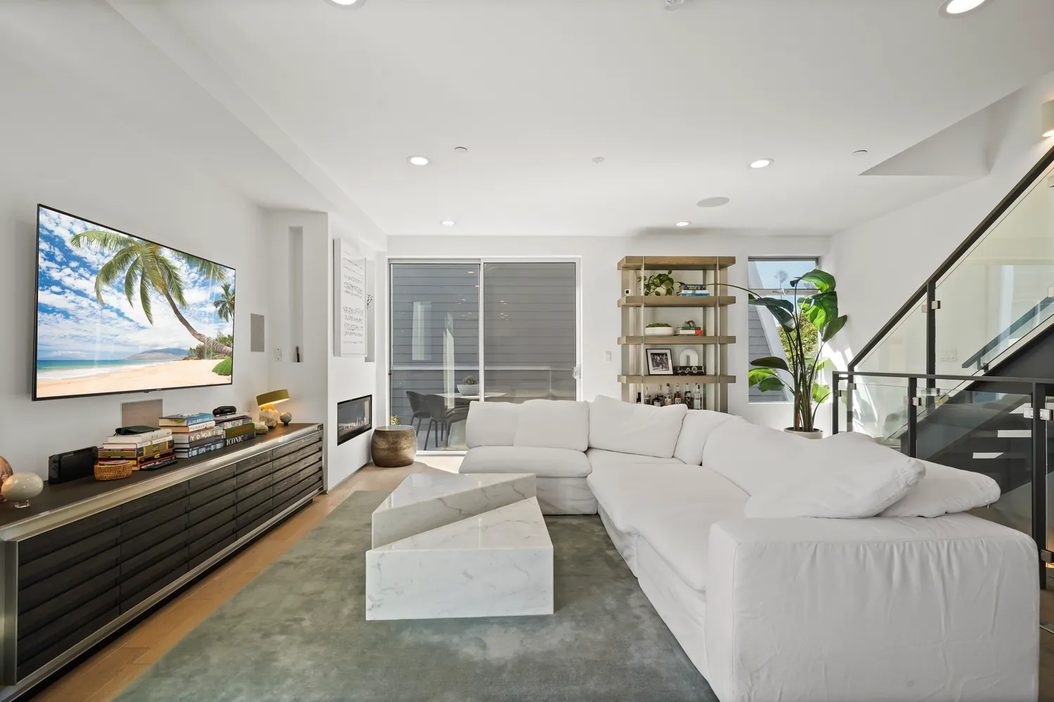 a living room with furniture fireplace and a large window