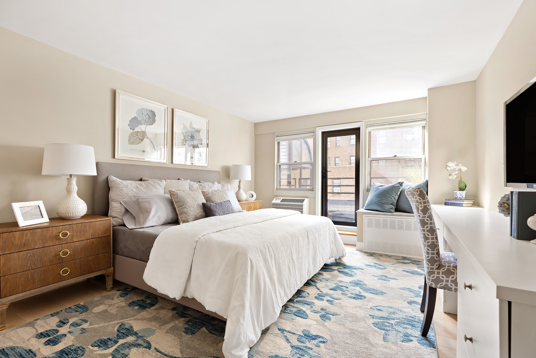 155 East 38th Street, Unit 12K Manhattan, NY 10016 - Photo 8 of 15 a bedroom with double bed windows and a flat screen tv