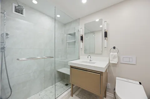 a bathroom with a sink toilet and shower