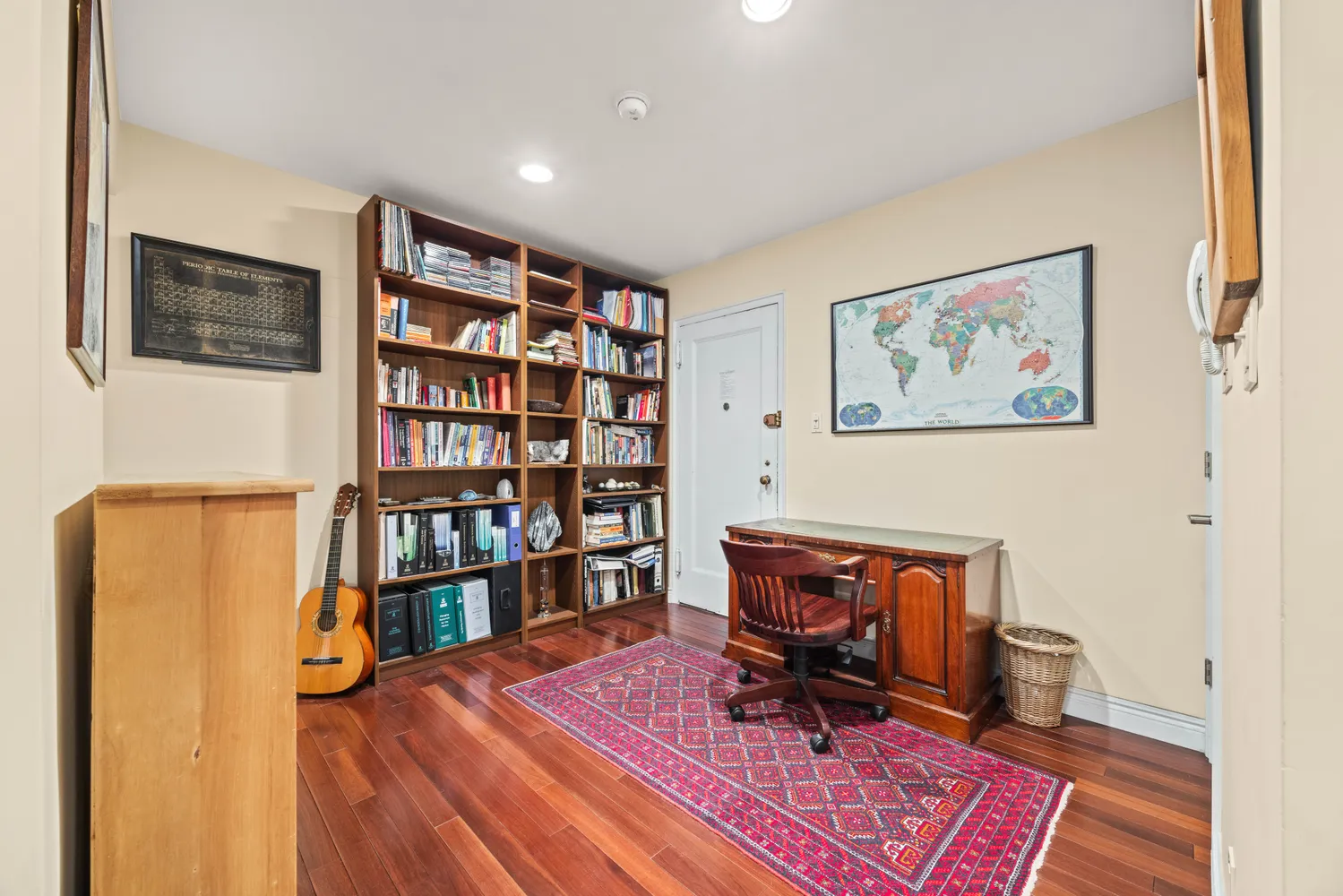 a view of a workspace with furniture and book shelf