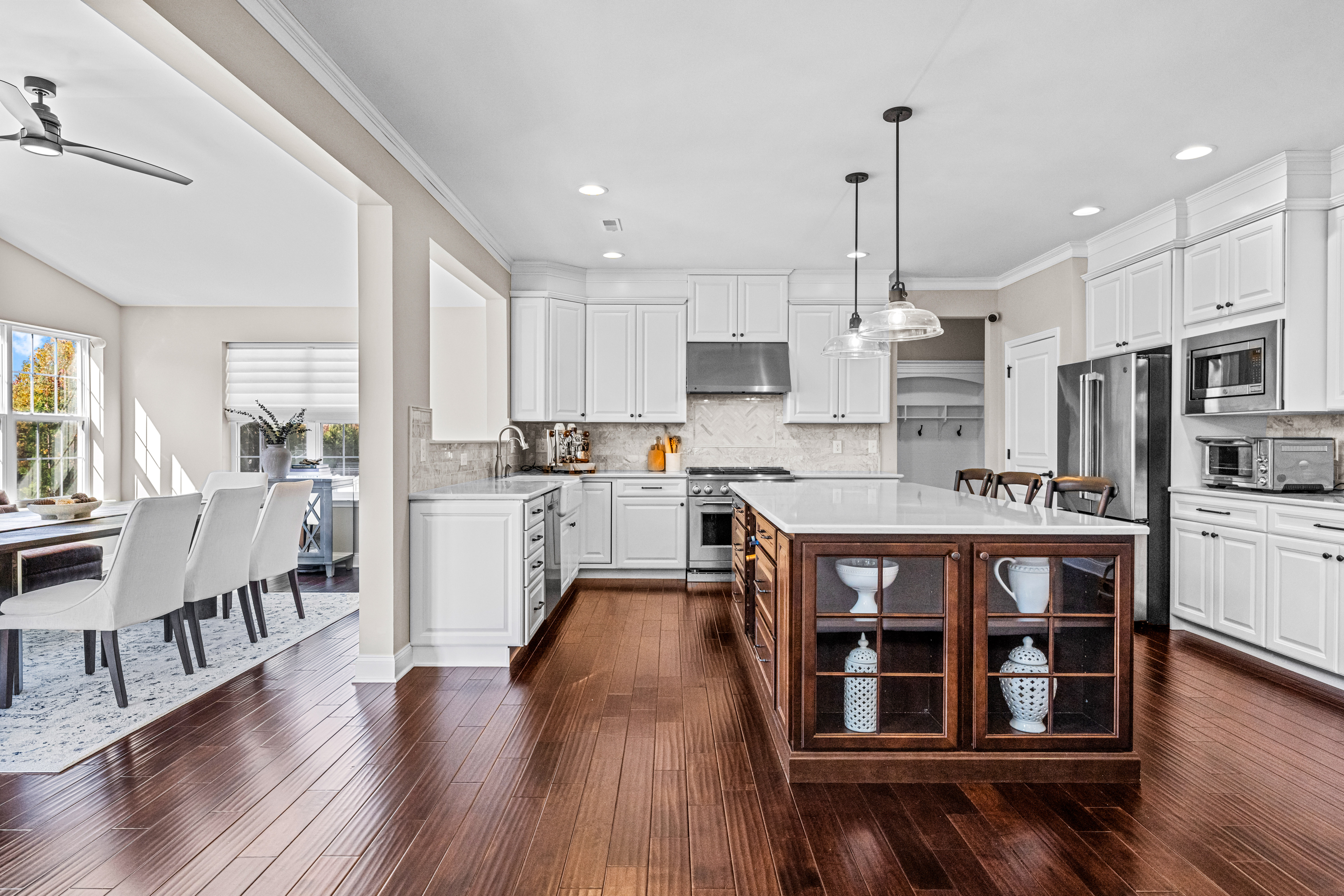 52 Wellesley Way Marlton, NJ 08053 - Photo 45 of 98 a open kitchen with stainless steel appliances granite countertop a stove top oven a refrigerator a dining table and chairs with wooden floor