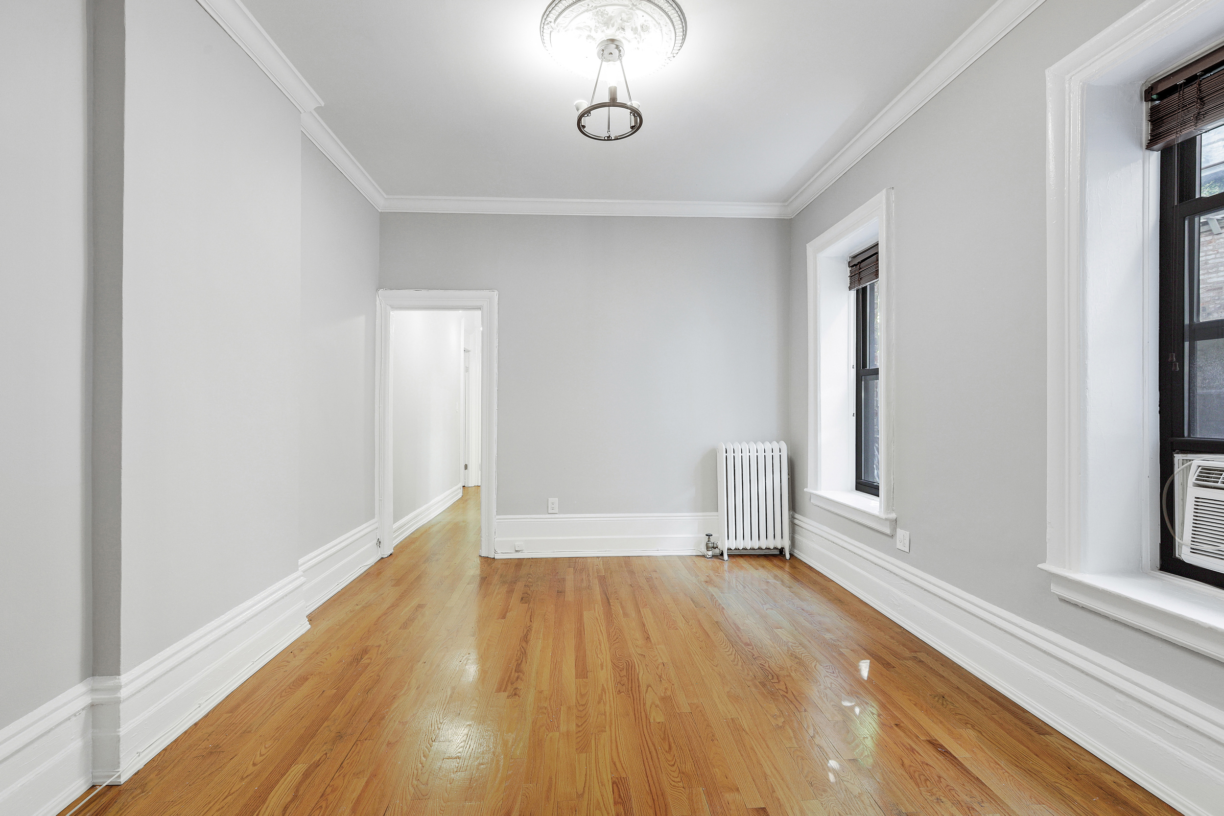 175 Prospect Park Southwest, Unit 1C Brooklyn, NY 11218 - Photo 6 of 12 a view of empty room with wooden floor and fan