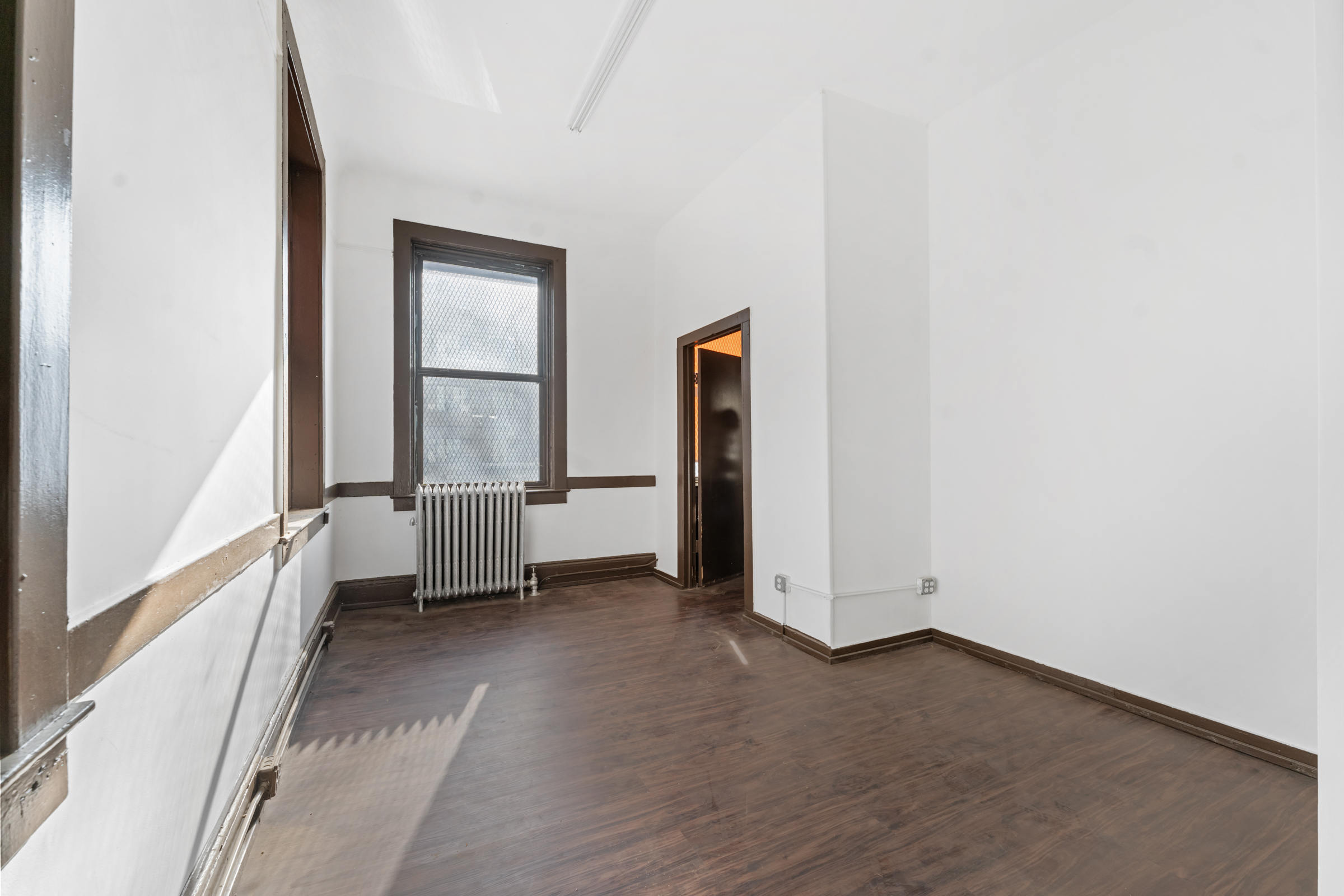 187 Maujer Street Brooklyn, NY 11206 - Photo 4 of 12 an empty room with windows