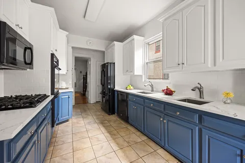 a kitchen with stainless steel appliances granite countertop a stove and a sink