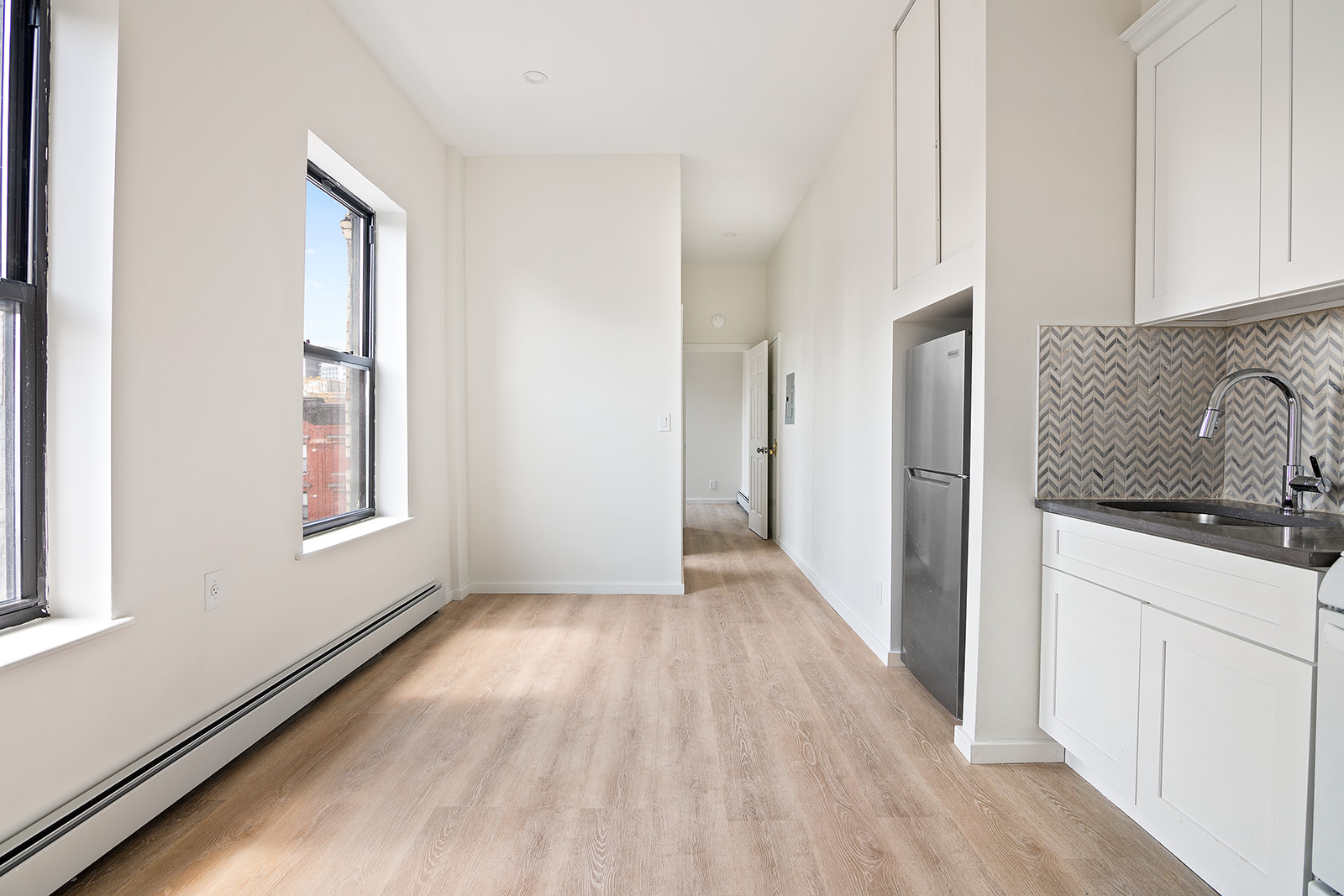 108 Stanton Street, Unit 5D Manhattan, NY 10002 - Photo 3 of 6 a view of a kitchen from the hallway
