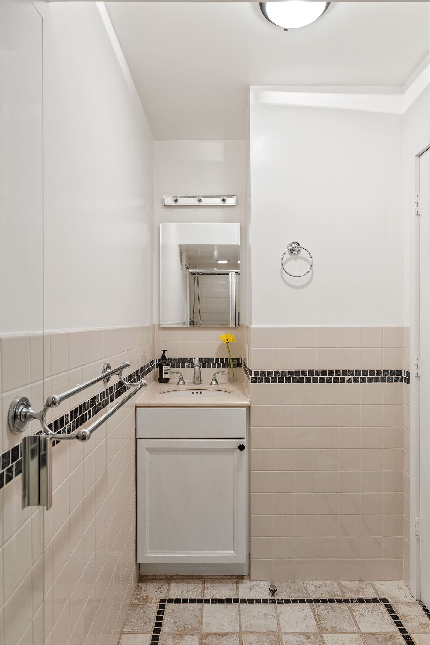2166 Broadway, Unit 17C Manhattan, NY 10024 - Photo 10 of 11 a bathroom with a granite countertop sink a mirror and a shower