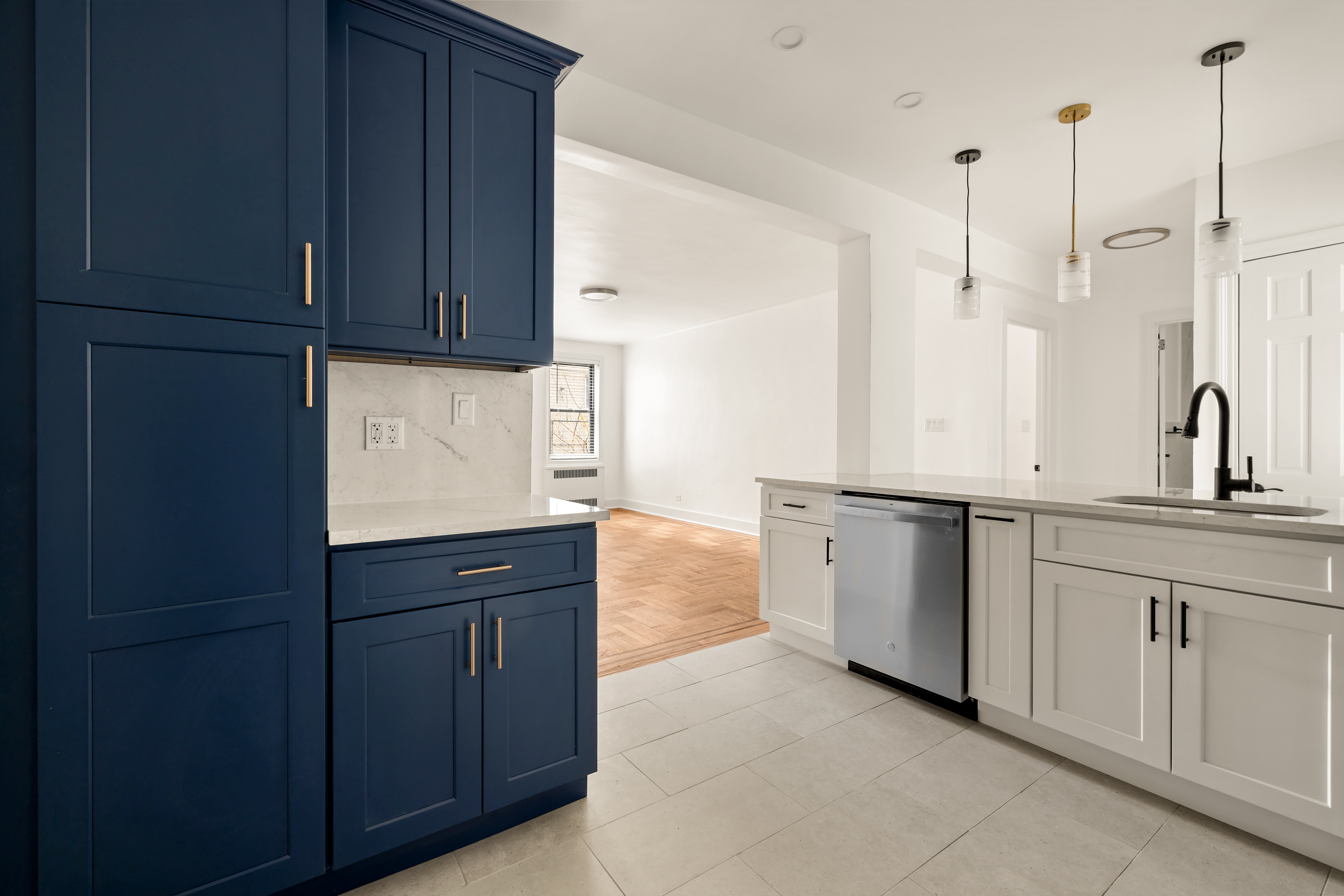 47-39 40th Street, Unit 1B Queens, NY 11104 - Photo 3 of 15 a kitchen with granite countertop white cabinets and sink