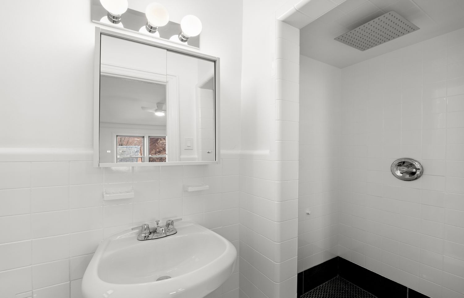 a bathroom with a sink a mirror and vanity