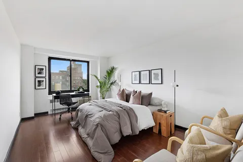 a bedroom with two beds and a large window