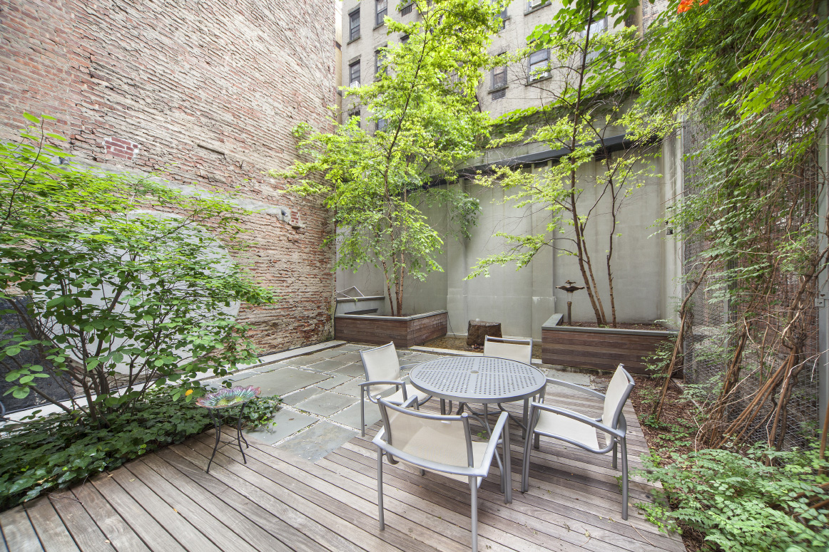 420 West 25th Street, Unit 3B Manhattan, NY 10001 - Photo 11 of 15 a backyard of a house with table and chairs wooden floor and fence