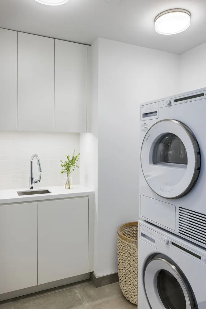 a utility room with sink dryer and washer