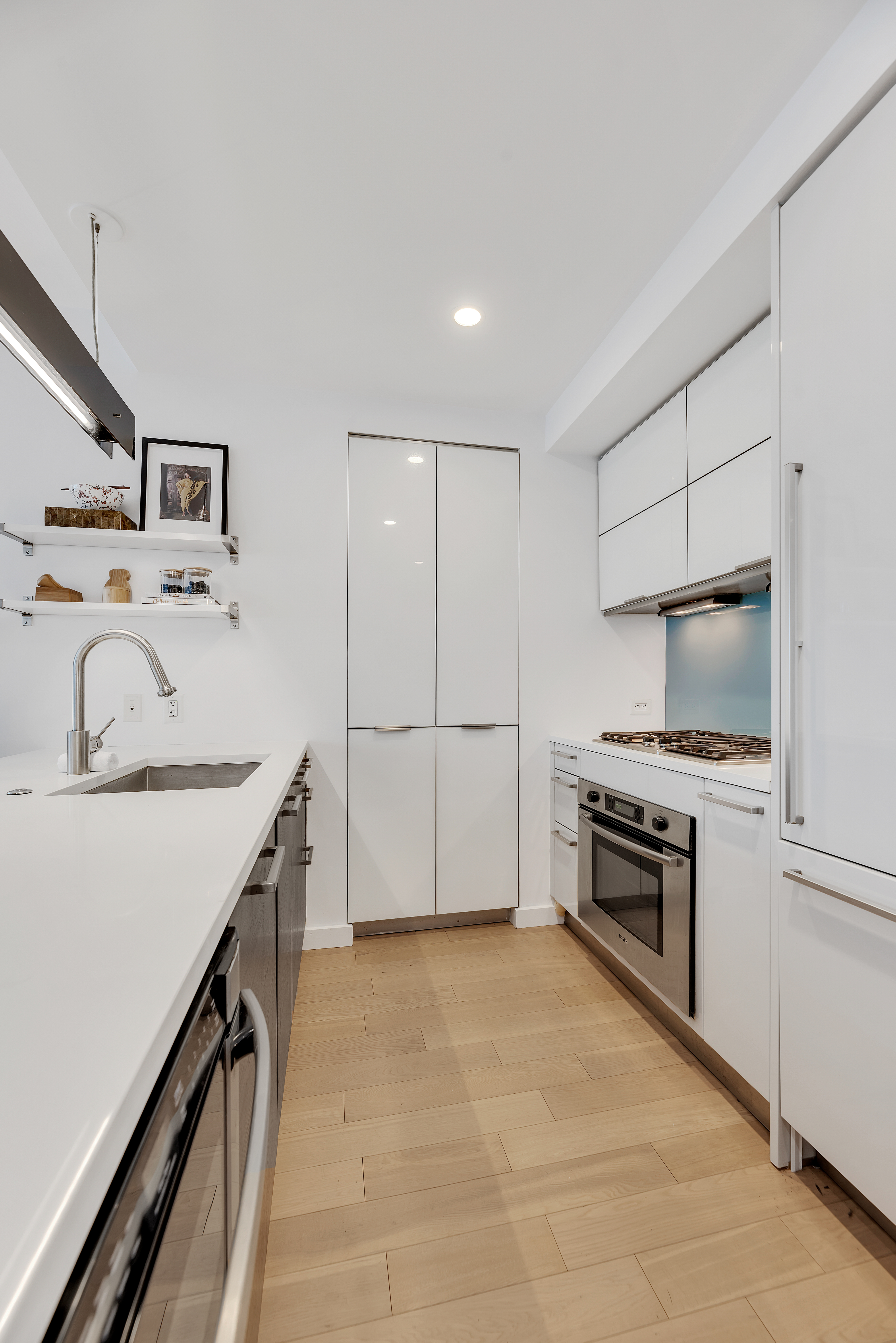 34 North 7th Street, Unit 7E Brooklyn, NY 11249 - Photo 3 of 20 a kitchen with kitchen island a stove a sink and a refrigerator