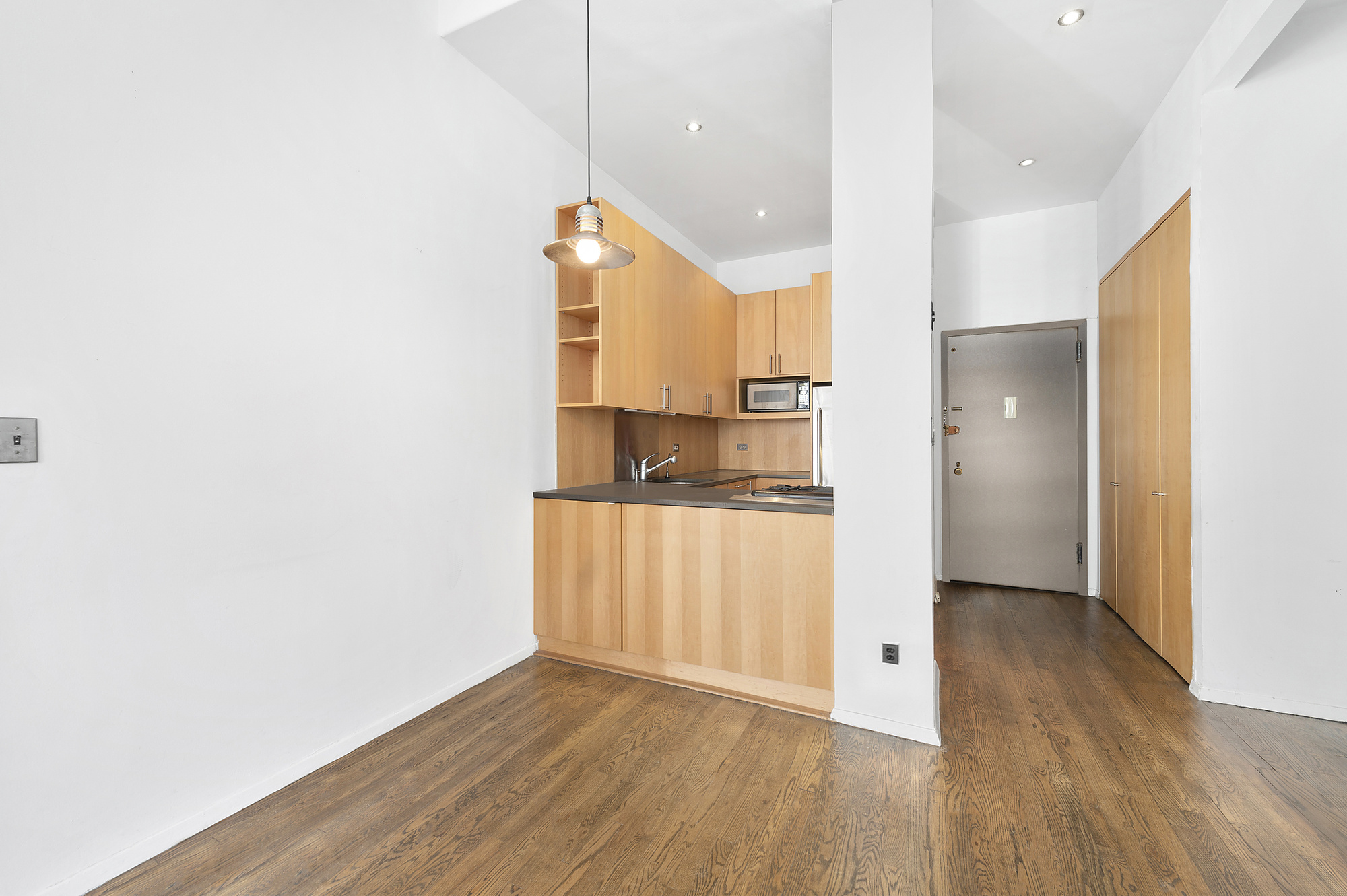 250 Mercer Street, Unit D603 Manhattan, NY 10012 - Photo 4 of 20 a view of a kitchen with a sink and cabinets