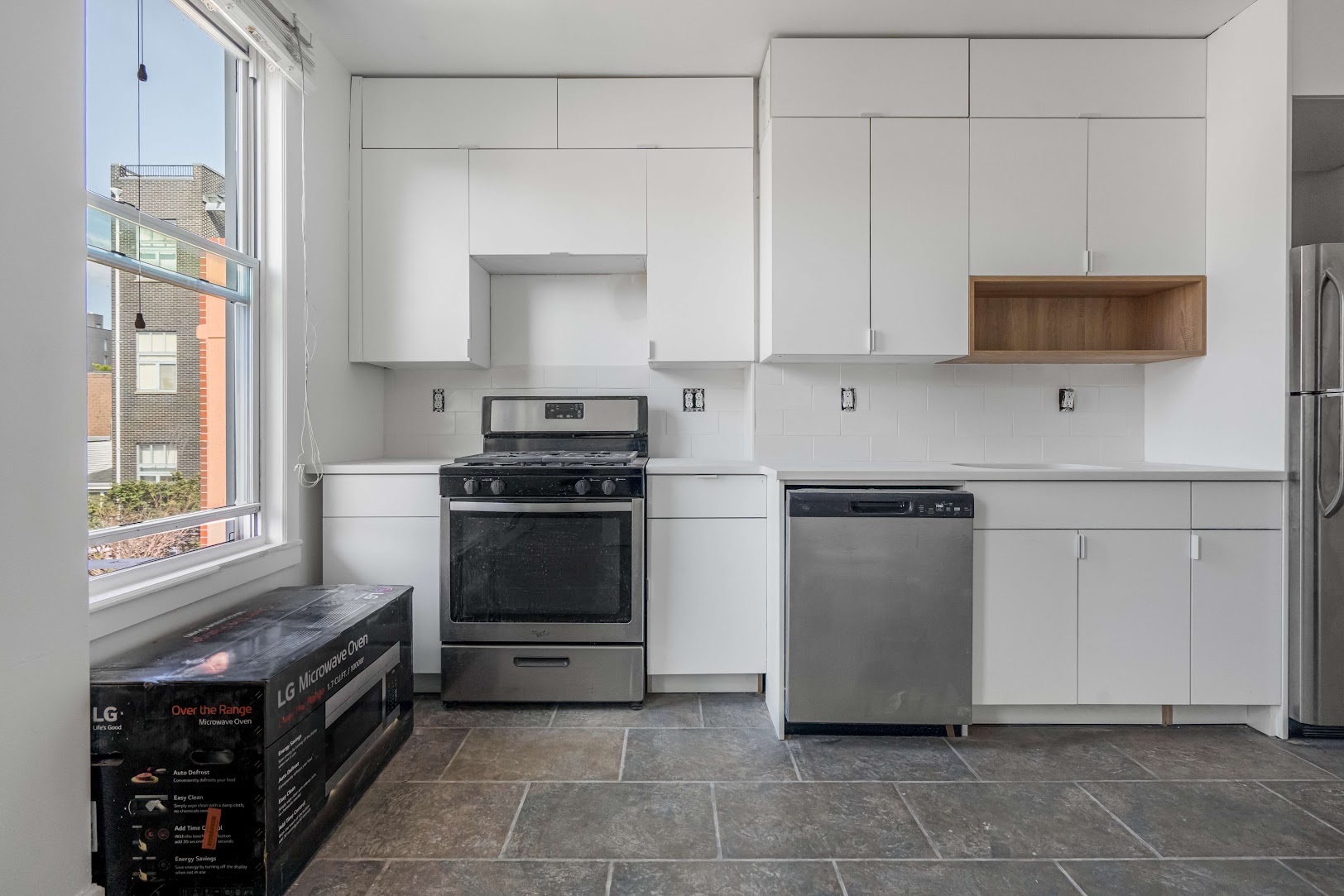 185 A Powers Street, Unit 3 Brooklyn, NY 11211 - Photo 1 of 12 a kitchen with stainless steel appliances a stove sink and microwave