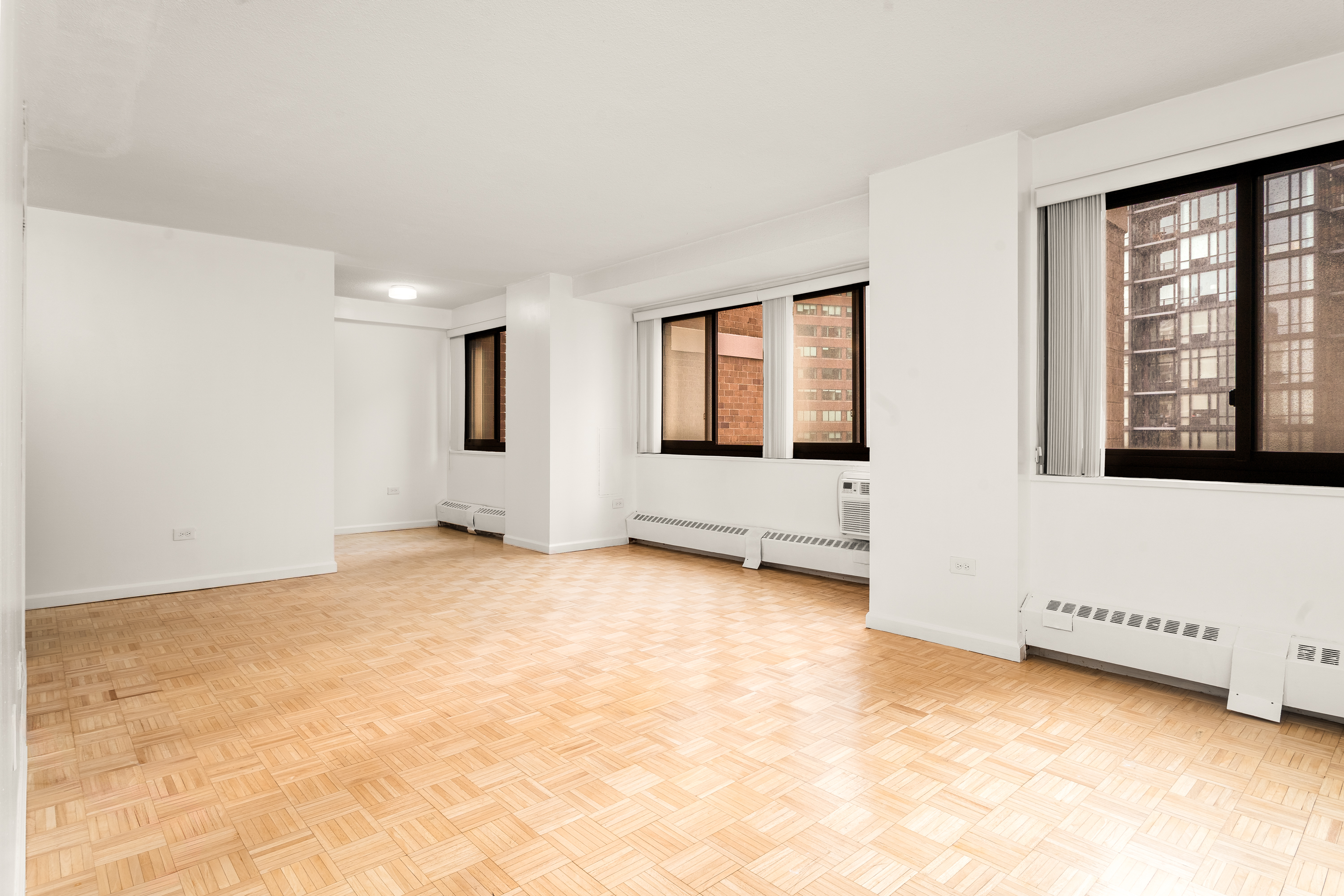 77 Fulton Street, Unit 18G Manhattan, NY 10038 - Photo 3 of 8 a view of an empty room with a window