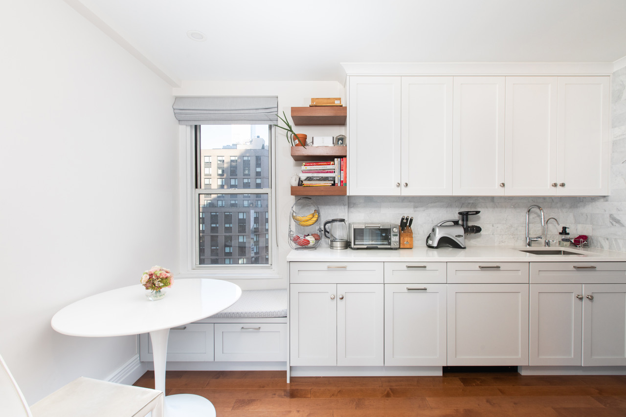 433 West 34th Street, Unit 8A Manhattan, NY 10001 - Photo 4 of 12 a kitchen with stainless steel appliances cabinets and a window