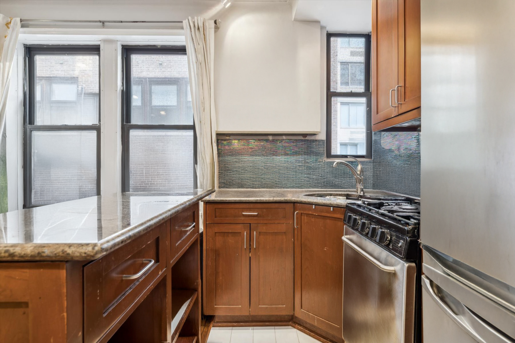 225 West 25th Street, Unit 4B Manhattan, NY 10001 - Photo 5 of 6 a kitchen with a refrigerator a stove and a sink
