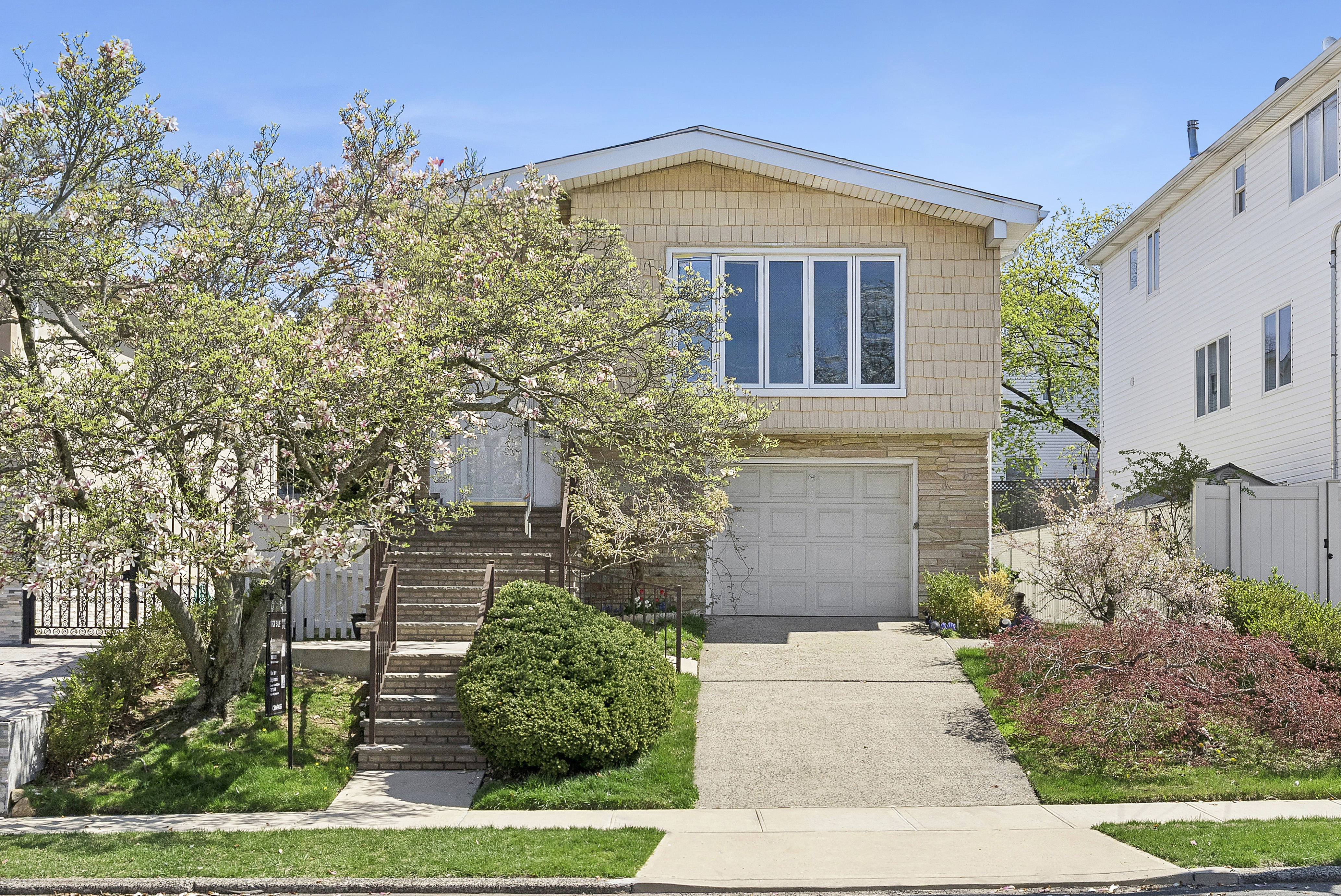 a front view of a house with garden