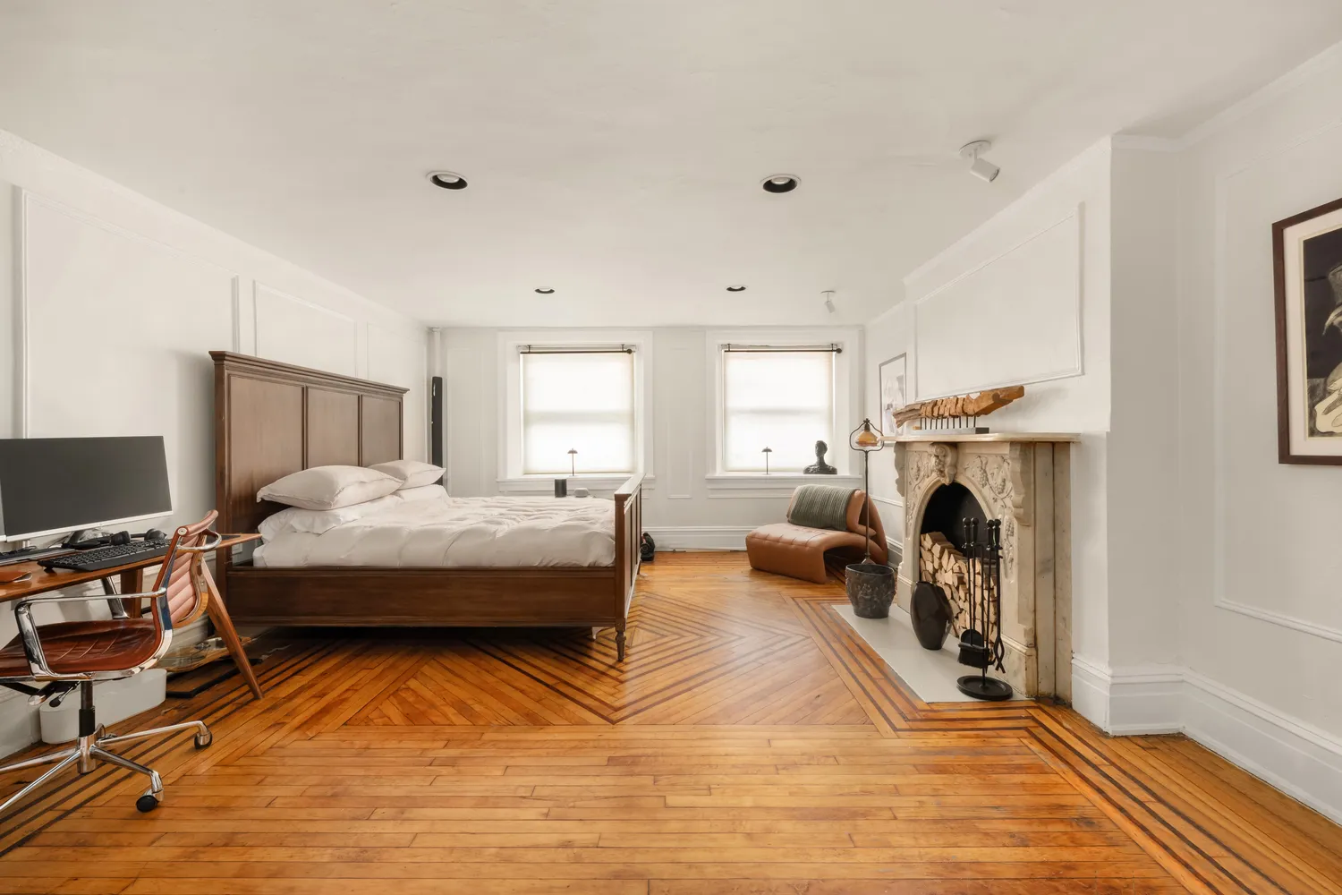 a spacious bedroom with a bed and a fireplace