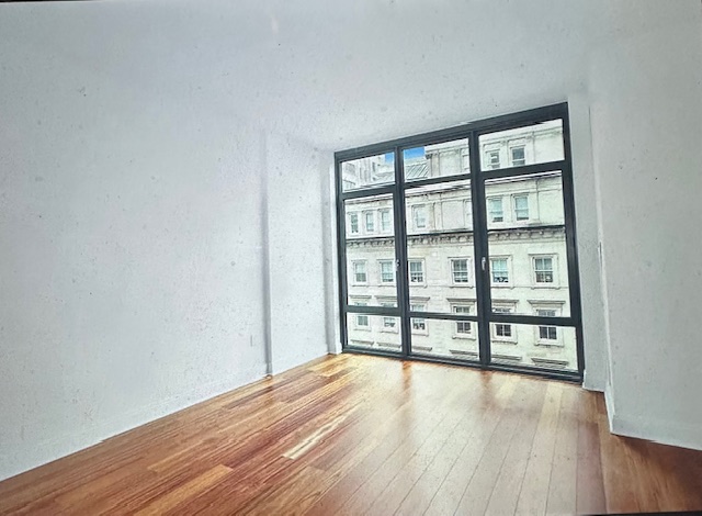57 Reade Street, Unit 7A Manhattan, NY 10007 - Photo 2 of 5 wooden floor and windows in an empty room