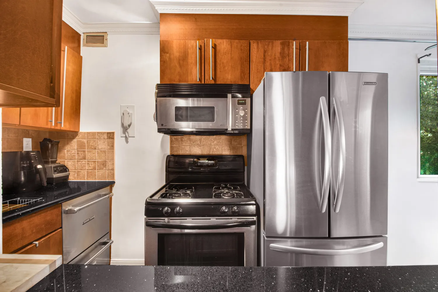 a kitchen with a stove and a refrigerator