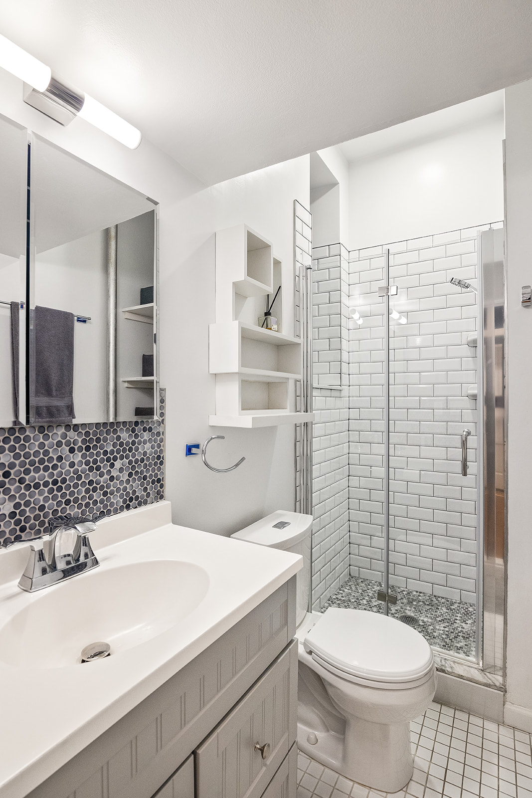 521 East 83rd Street, Unit 1W Manhattan, NY 10028 - Photo 5 of 7 a bathroom with a sink toilet and shower