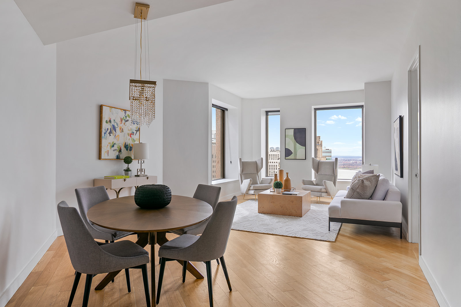 75 Wall Street, Unit 36F Manhattan, NY 10005 - Photo 2 of 15 a dining room with furniture and wooden floor