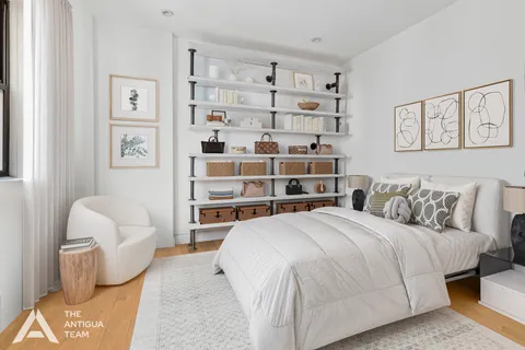 a spacious bedroom with a bed and a couch