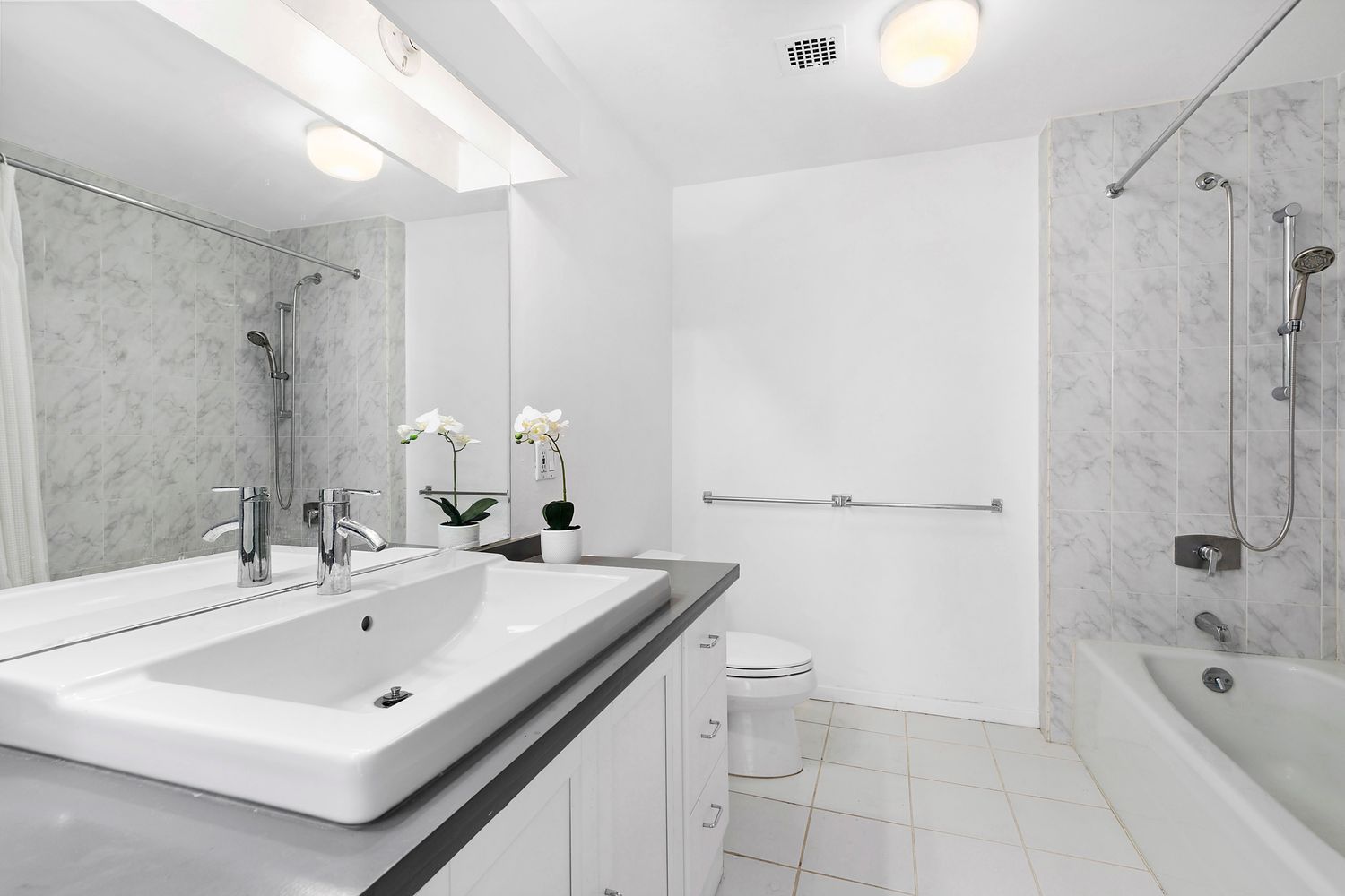 448 West 37th Street, Unit PHA Manhattan, NY 10018 - Photo 6 of 7 a bathroom with a sink a toilet and shower