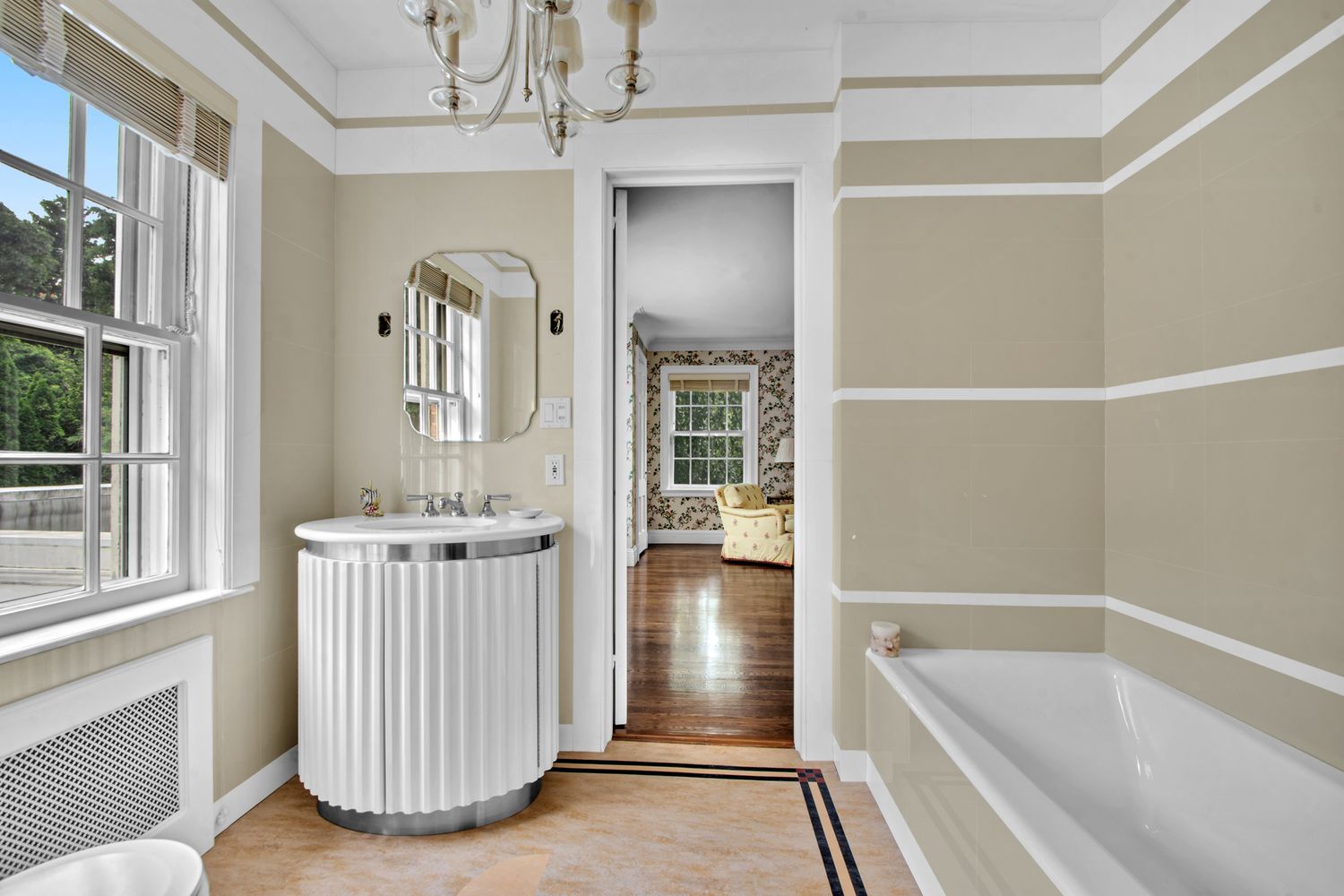 a bathroom with a tub sink and mirror