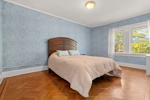 a bedroom with a bed and window