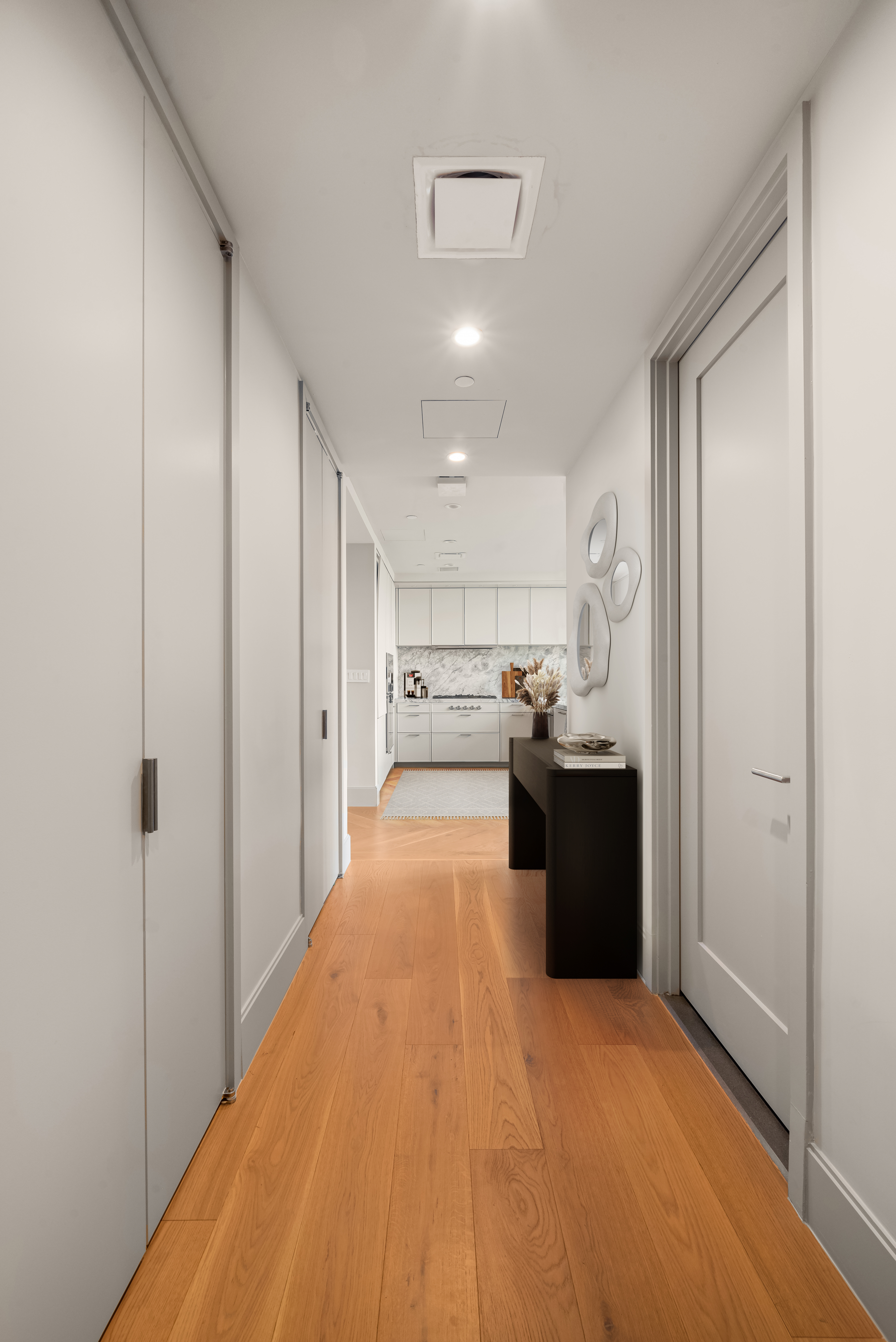 1059 3rd Avenue, Unit 21B Manhattan, NY 10065 - Photo 4 of 13 a view of a kitchen with a sink and dishwasher a refrigerator with wooden floor