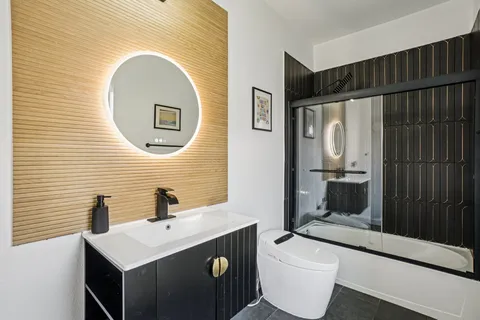 a bathroom with a toilet sink and mirror