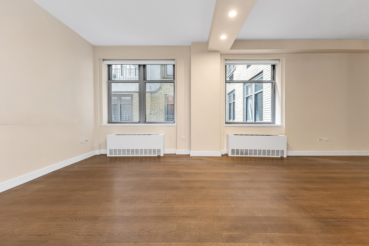 100 West 58th Street, Unit 12A Manhattan, NY 10019 - Photo 3 of 15 a view of an empty room with a window