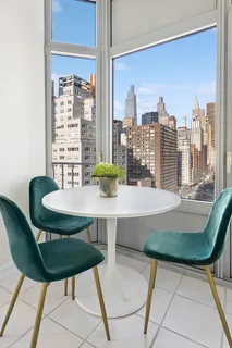 a view of a dining room with furniture and a window