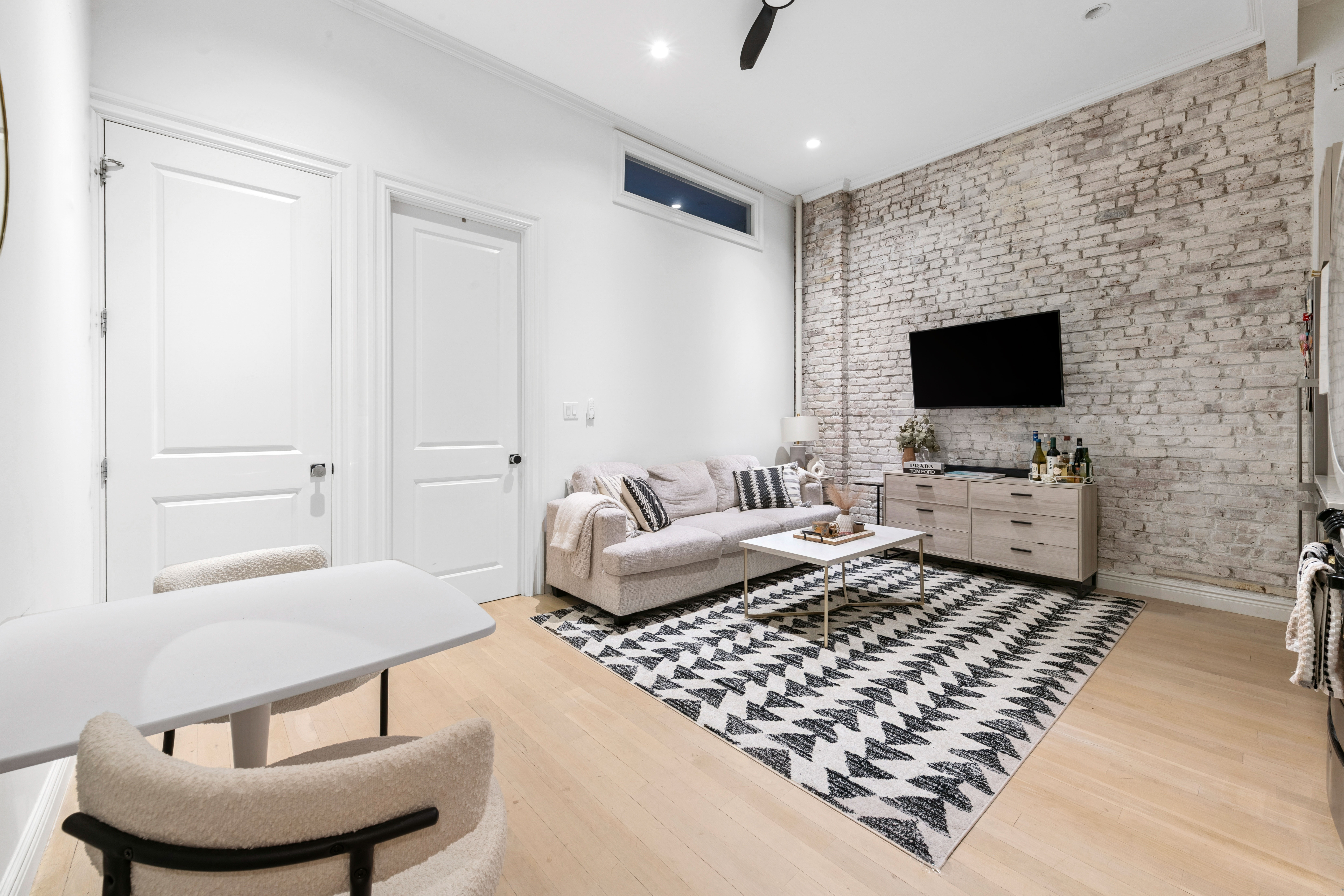 51 West 11th Street, Unit 1R Manhattan, NY 10011 - Photo 5 of 10 a living room with furniture and a flat screen tv