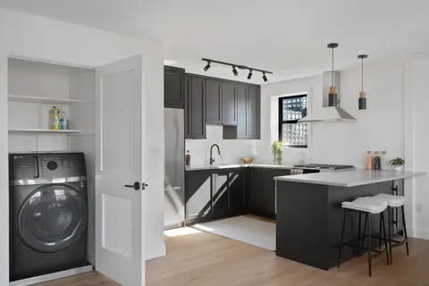 a kitchen with stainless steel appliances granite countertop a sink and a refrigerator
