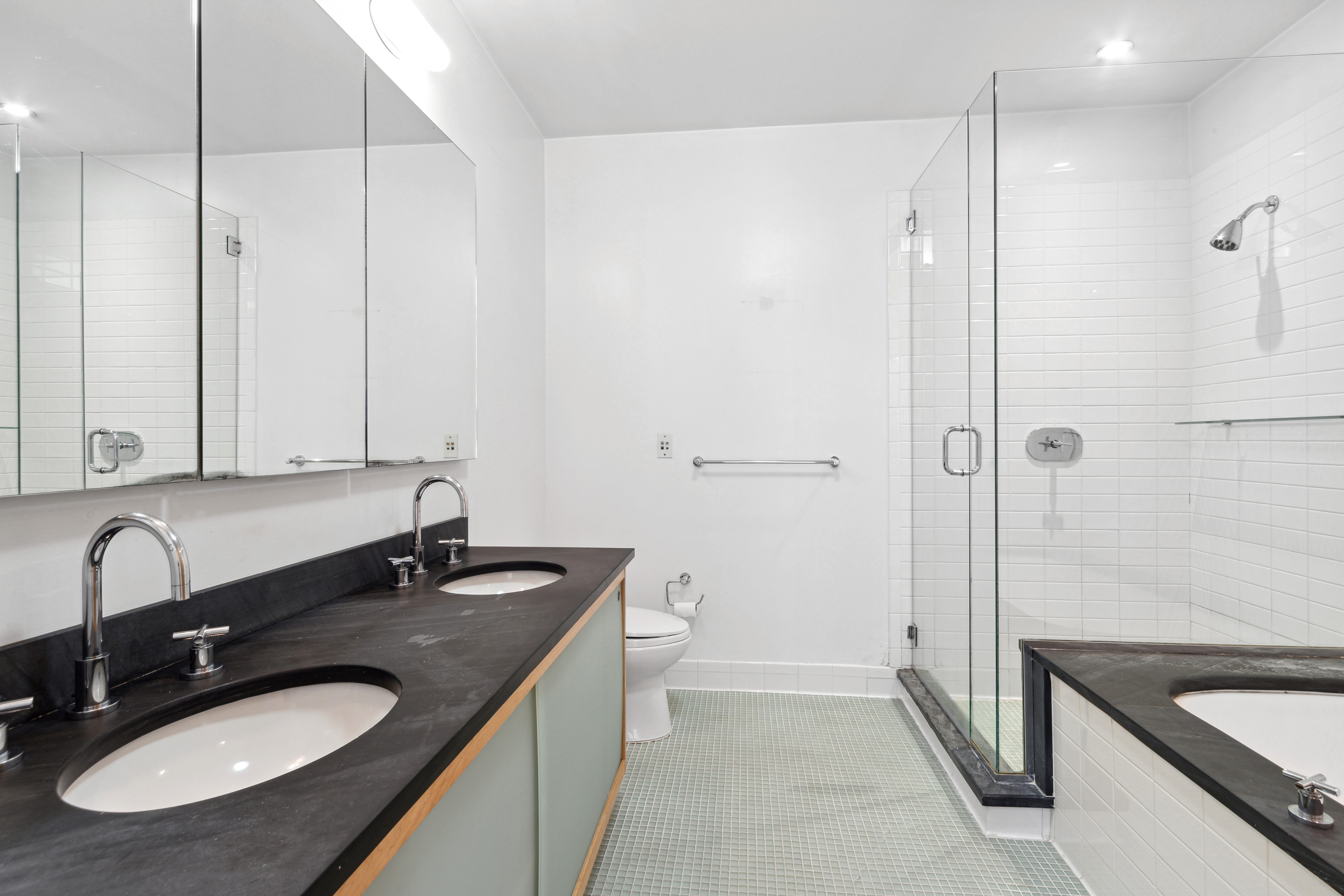 70 Washington Street, Unit 4U Brooklyn, NY 11201 - Photo 5 of 14 a bathroom with a sink double vanity granite tub shower and mirror