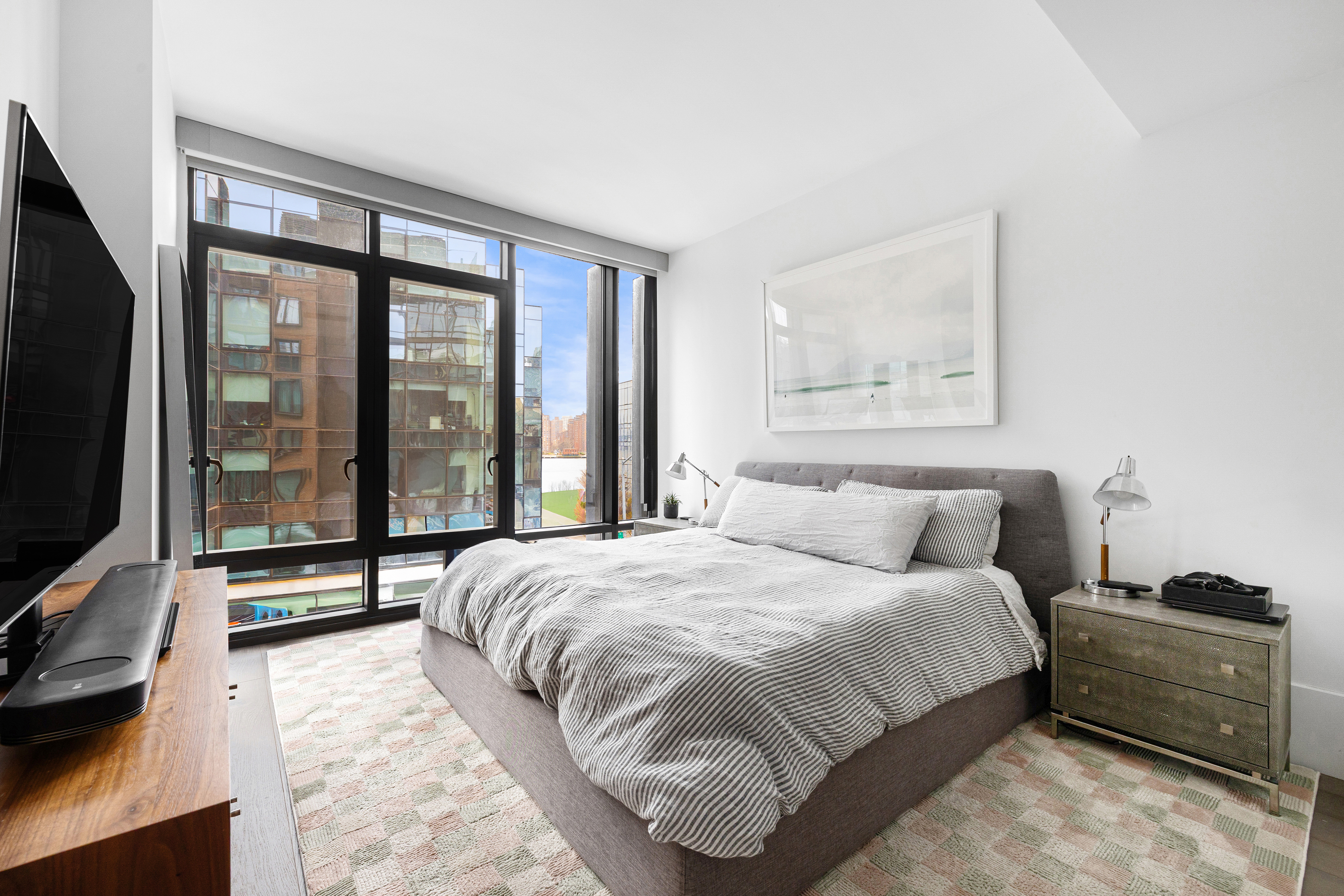 429 Kent Avenue, Unit 340 Brooklyn, NY 11249 - Photo 4 of 9 a bedroom with a bed and large window