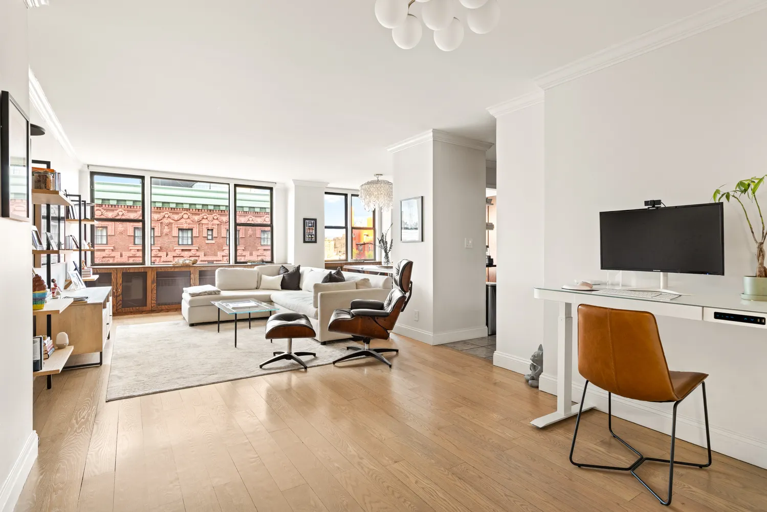 a view of a livingroom with workspace and a couch
