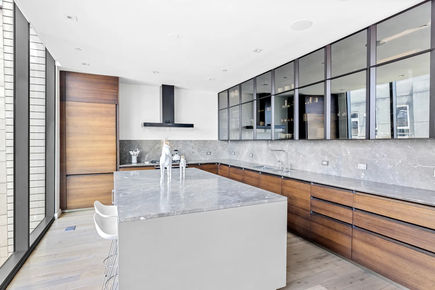 a kitchen with stainless steel appliances granite countertop a sink and a refrigerator