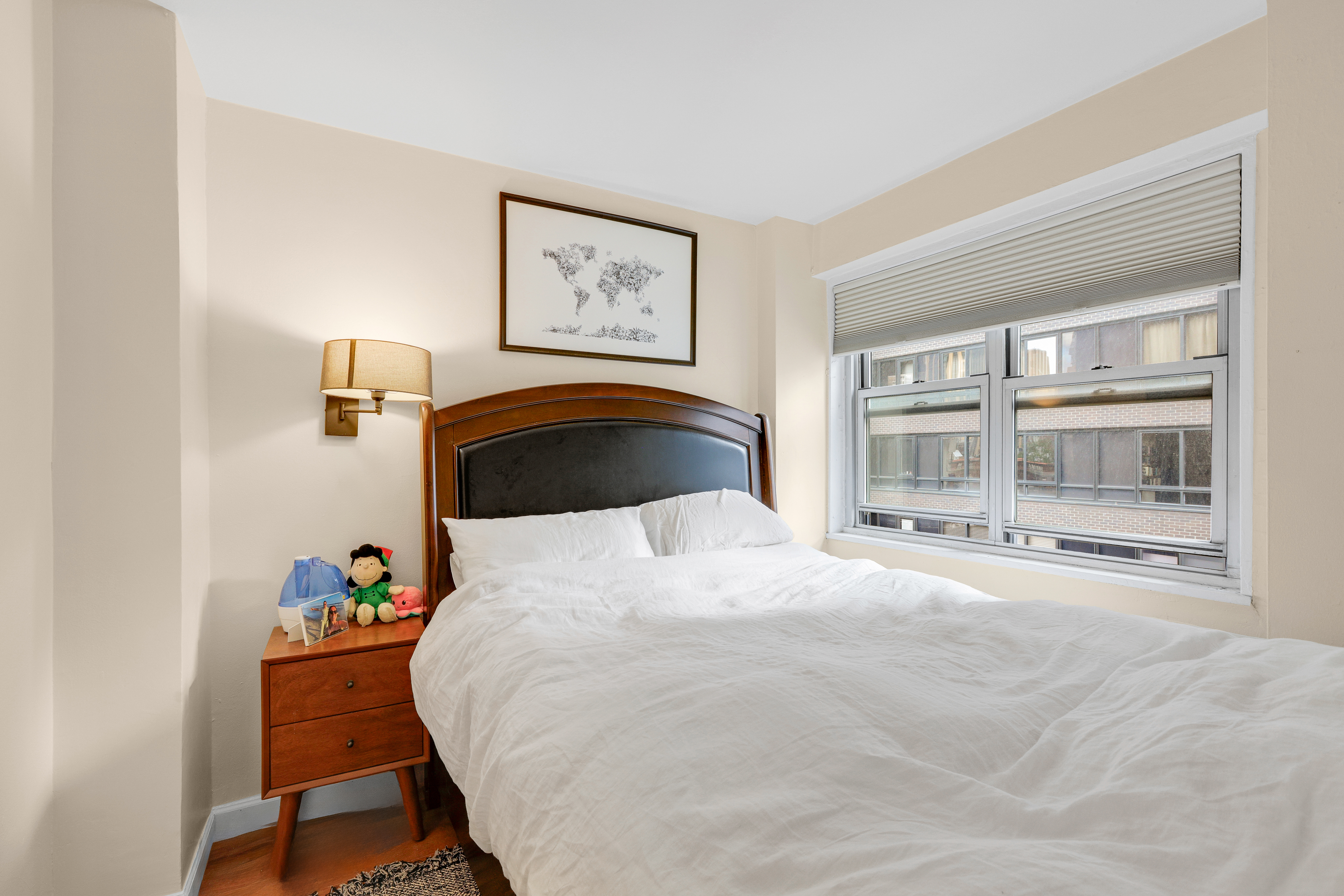 330 East 49th Street, Unit 9A Manhattan, NY 10017 - Photo 3 of 7 a bedroom with a bed and a large window
