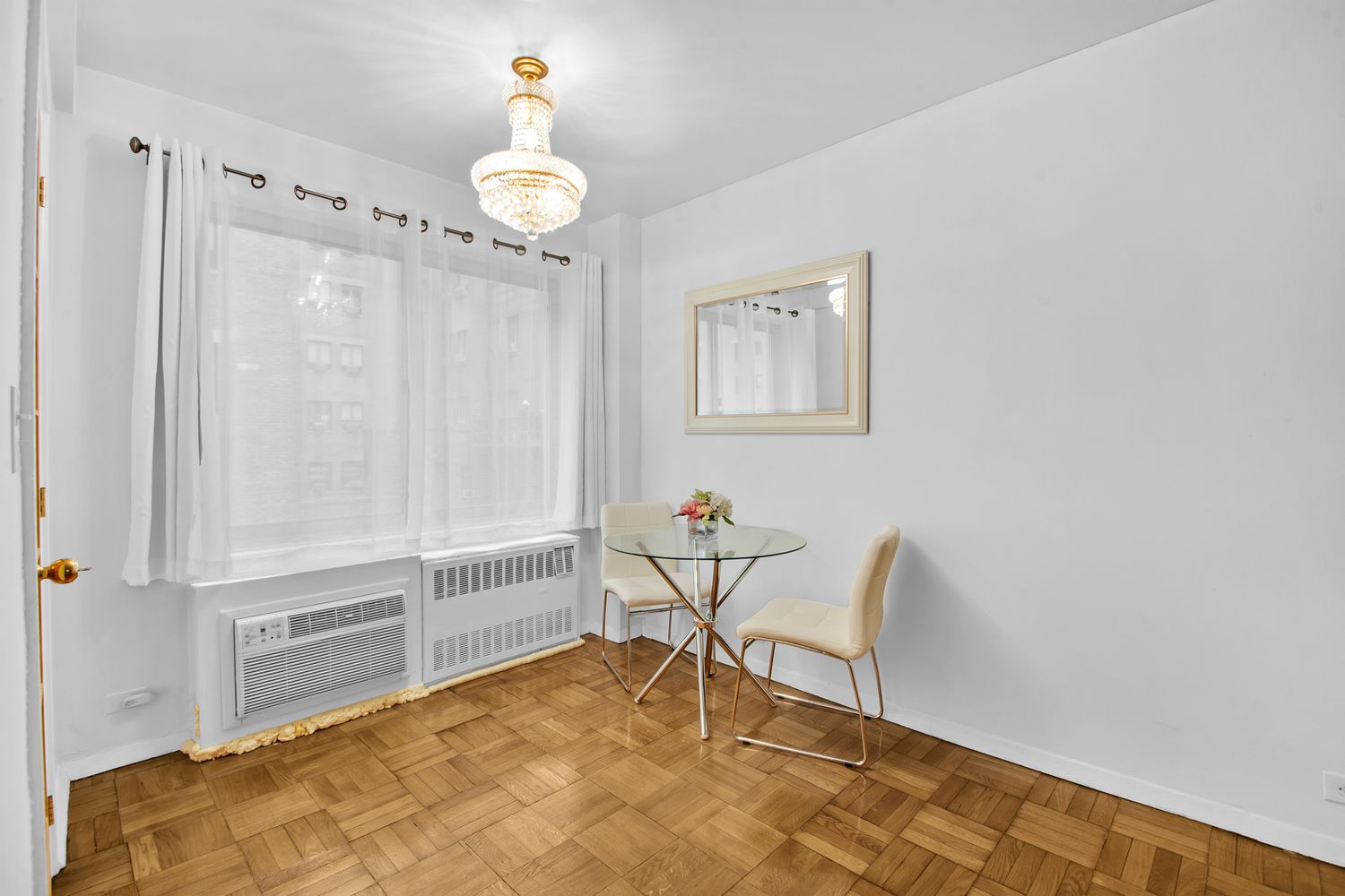 225 East 46th Street, Unit 4K Manhattan, NY 10017 - Photo 4 of 14 a view of a livingroom with furniture and chandelier