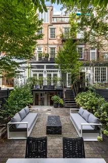 a view of house with a yard and potted plants