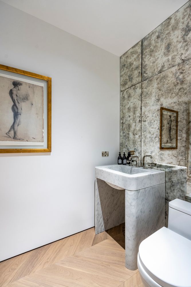 a bathroom with a toilet a sink and mirror