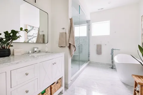 a spacious bathroom with a double vanity sink mirror and toilet