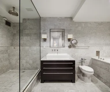 a bathroom with a sink a toilet and shower